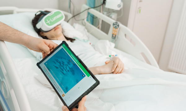 a patient in a hospital bed wearing a virtual reality headset