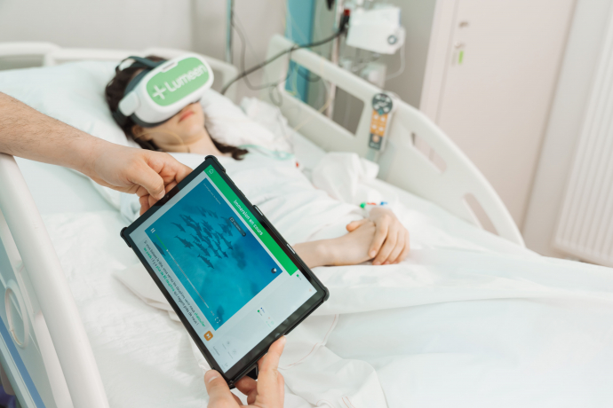 a patient in a hospital bed wearing a virtual reality headset